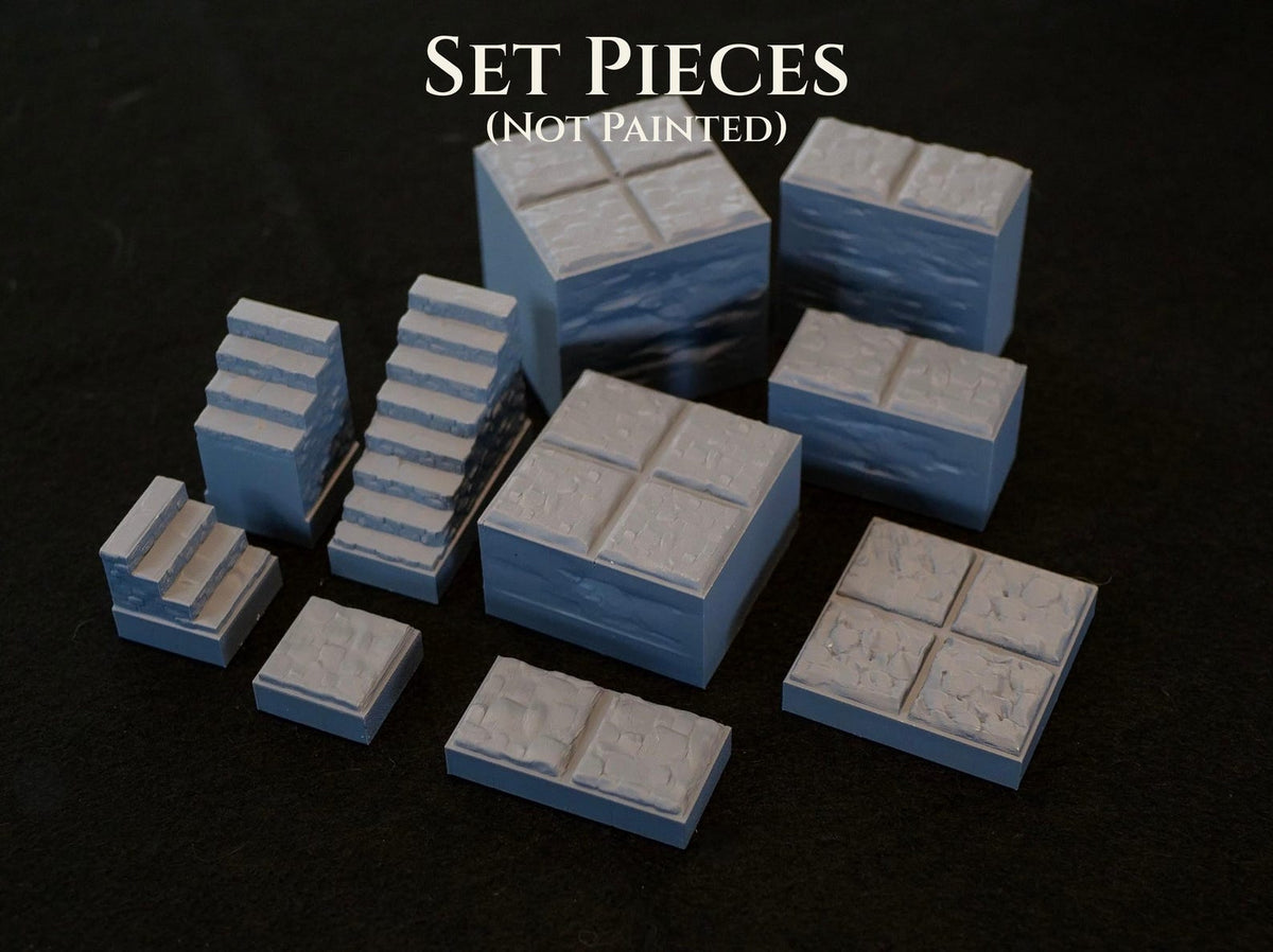 A collection of unpainted light gray miniature terrain set pieces for tabletop gaming. The set includes various stone-textured blocks, stairs, and floor tiles. The text "SET PIECES (NOT PAINTED)" is visible at the top of the image.