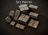 A collection of painted miniature set pieces featuring dark, weathered stone textures. The items include square blocks, rectangular platforms, and small staircases, all with a rugged, aged appearance. The text SET PIECES (PAINTED) is visible.