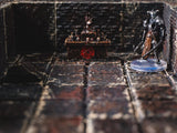 A miniature armored warrior figure stands on a circular base within a dark stone dungeon setting. Nearby, a small altar features a red pentagram symbol on its front, with skulls and a flame-like structure resting on its top surface.