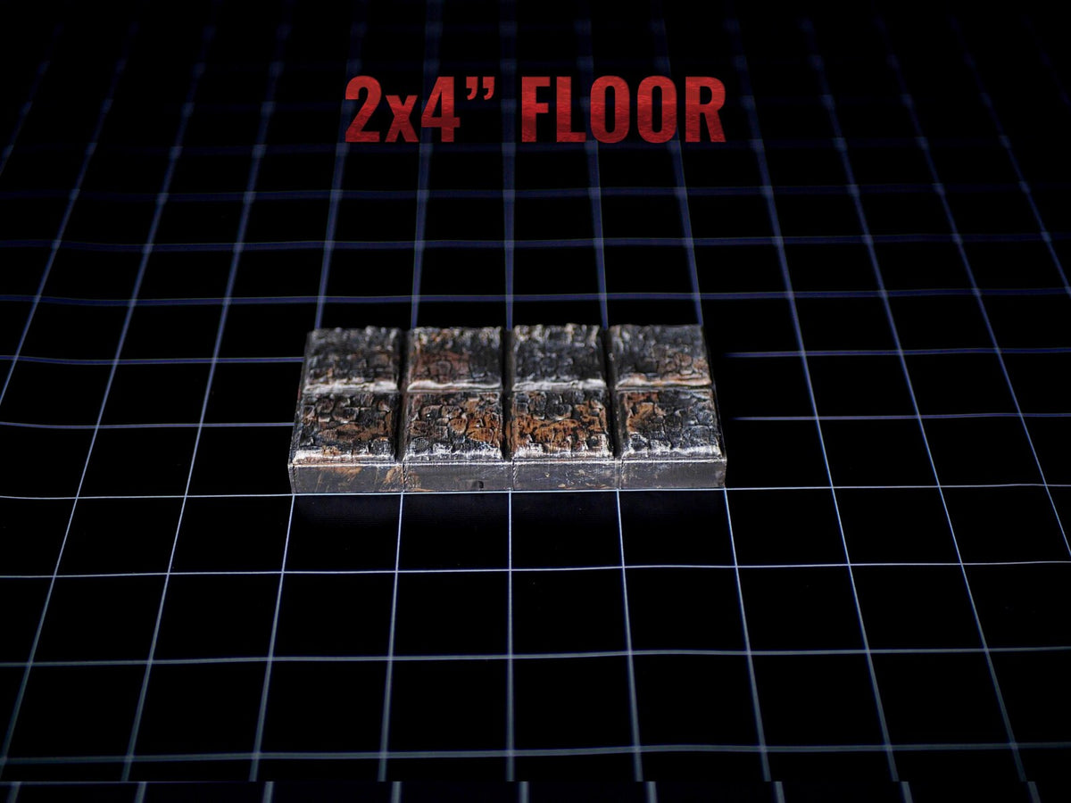 A rectangular floor tile piece featuring a grid of eight square sections with a weathered, metallic, and rusted texture. The text 2x4" FLOOR is printed in red above the object, which is set against a black grid background.