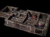 A detailed, modular dungeon terrain set, featuring brick-textured walls and floors. The set includes stairs, doorways, and miniature figurines, creating a realistic environment for tabletop gaming. The color palette is primarily dark brown and gray.