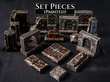 A collection of painted miniature dungeon set pieces featuring stone walls, floor tiles, a gated archway, and a central altar. The text SET PIECES (PAINTED) is displayed at the top. These dark, weathered gray and brown textured terrain components are designed for tabletop gaming.