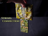 A set of three square tiles with a textured, mossy green and yellow finish, featuring raised organic patterns. The tiles are connected vertically, and the text "STRONG CONNECTION" is printed in yellow on the left side of the image.
