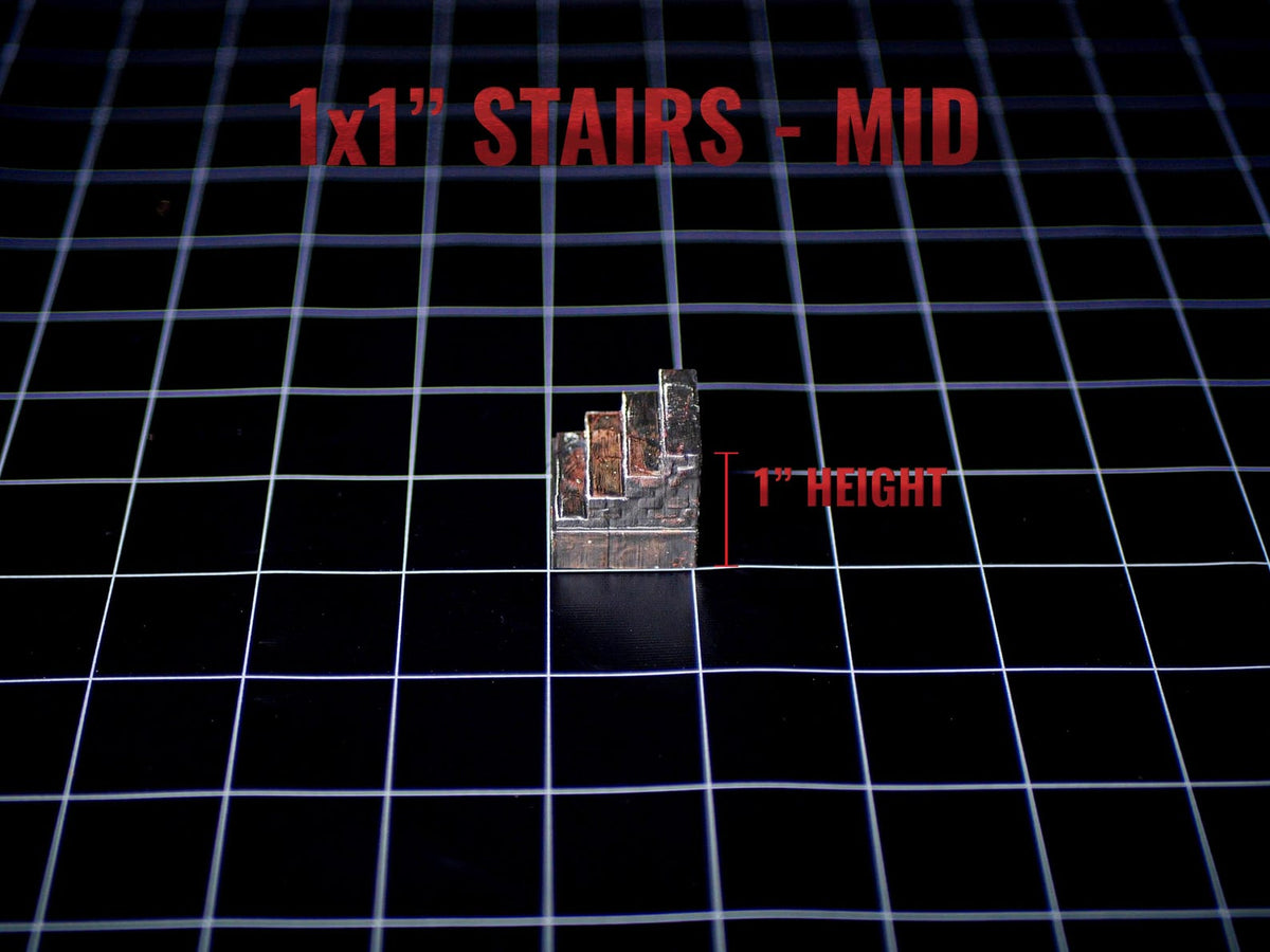A miniature set of stairs with a stone-like texture and dark grey and brown coloring. The object is labeled 1x1" STAIRS - MID and 1" HEIGHT, indicating a 1-inch height measurement on a black grid background for tabletop gaming.