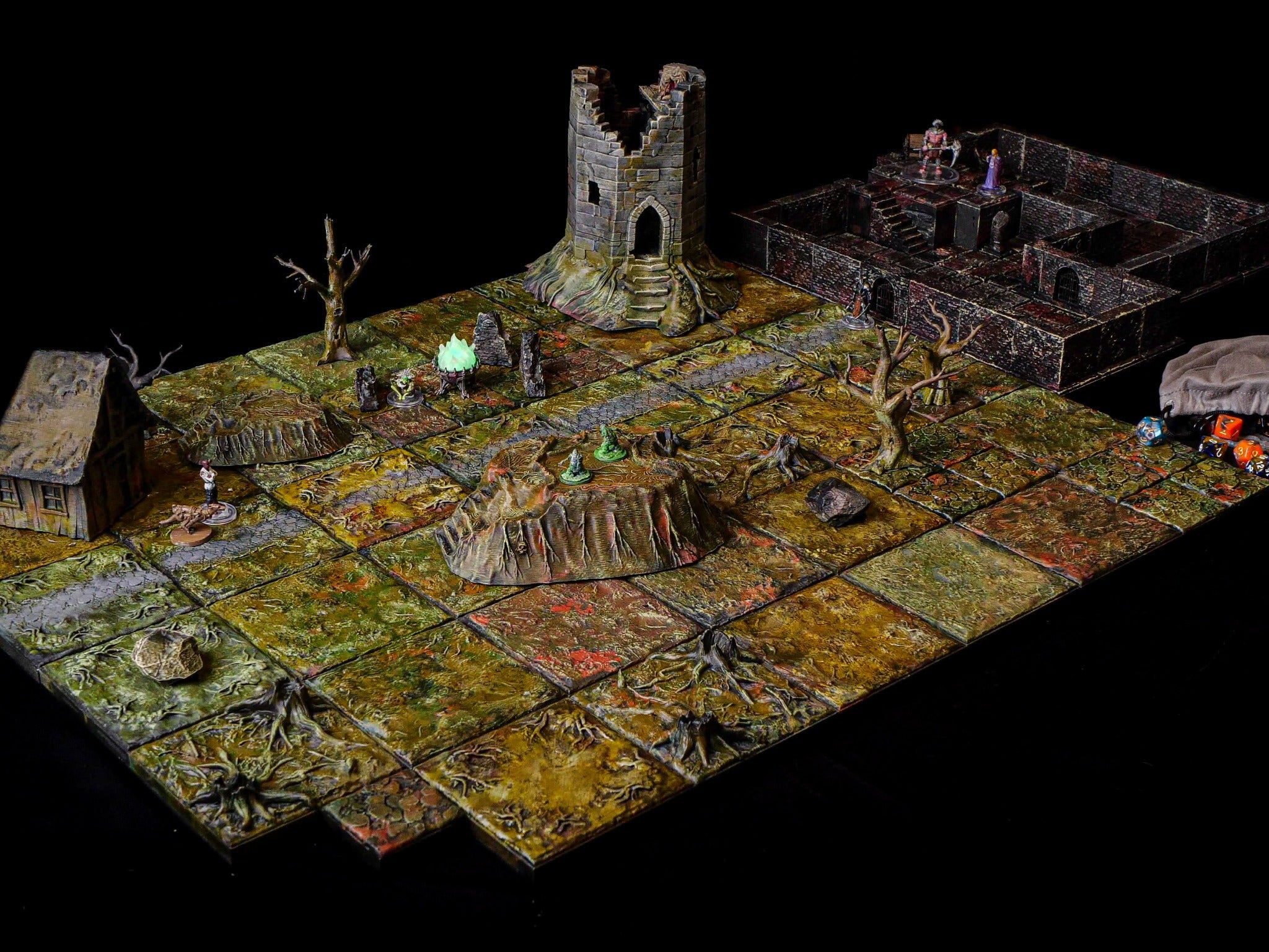 A complete tabletop scene combining swamp paths, tangled roots, a ruined tower, a house and a multi-level stone dungeon